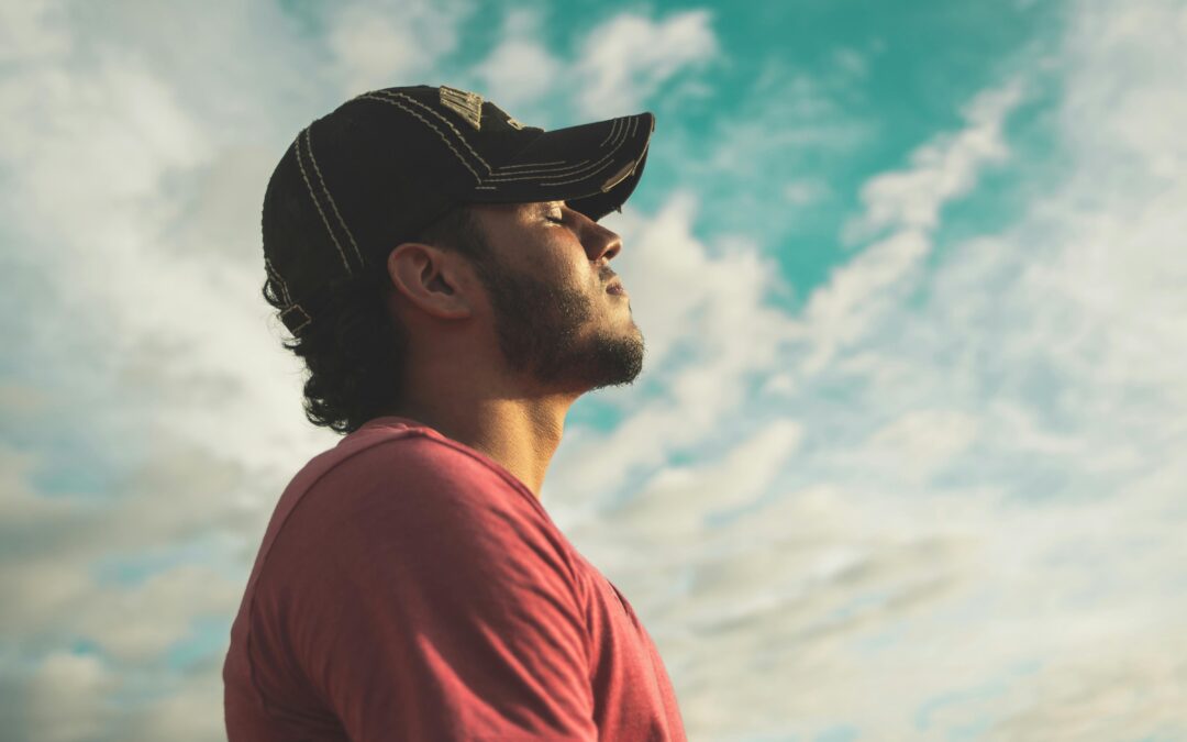 Photo by Kelvin Valerio: https://www.pexels.com/photo/man-wearing-black-cap-with-eyes-closed-under-cloudy-sky-810775/